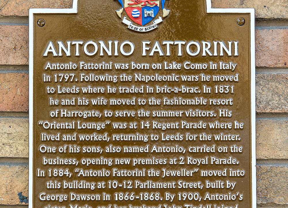 Photo of wall plaque with biographical text about Antonio Fattorini