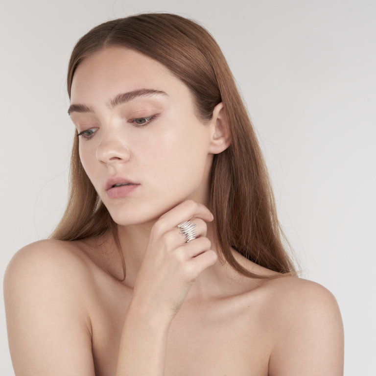 Image of a lady wearing a Shaun Leane Silver Quill Wrap Ring