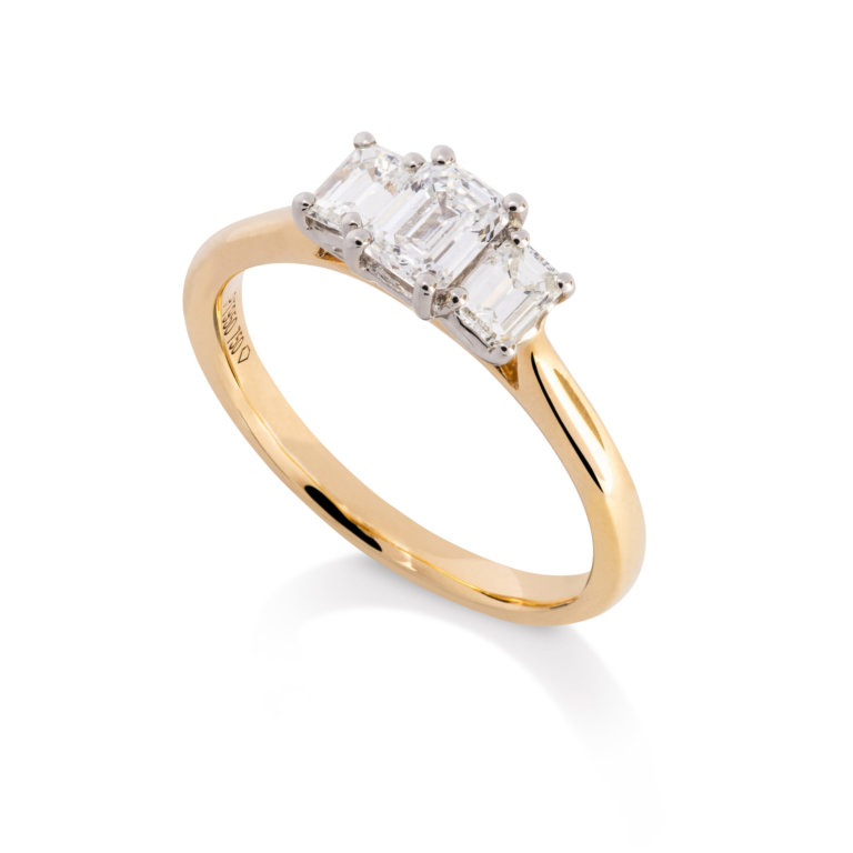 Image of an Emerald Cut 0.77ct Diamond Three Stone Ring in yellow gold and platinum