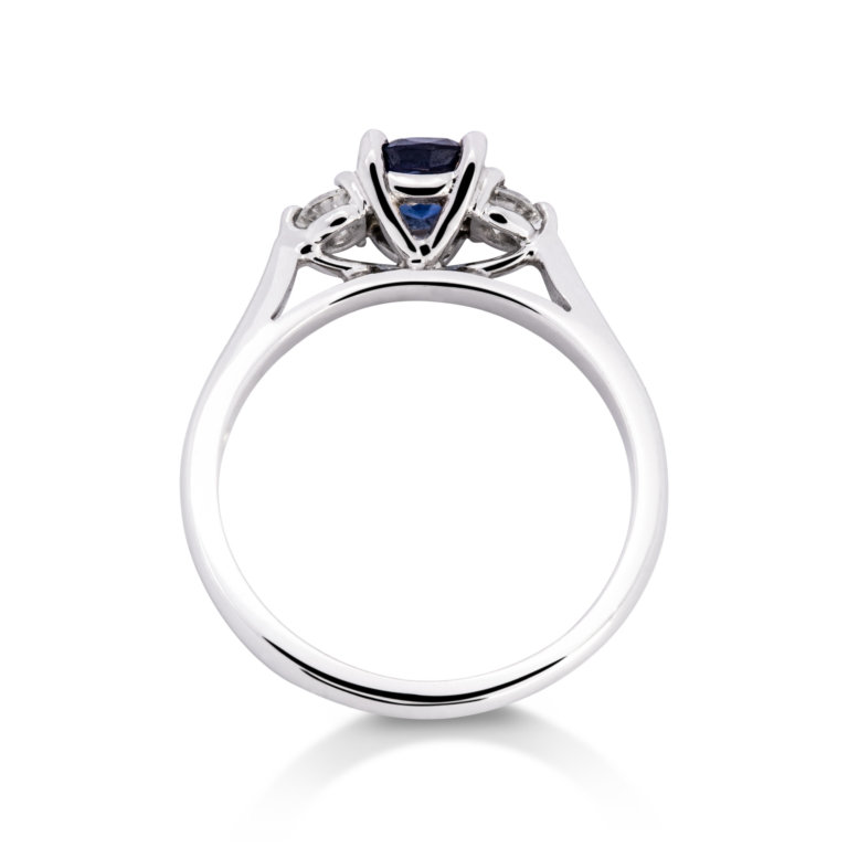 Image of a Cushion Sapphire and Brilliant Cut Diamond Three Stone Ring in white gold