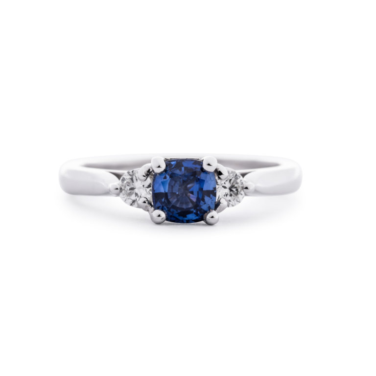 Image of a Cushion Sapphire and Brilliant Cut Diamond Three Stone Ring in white gold