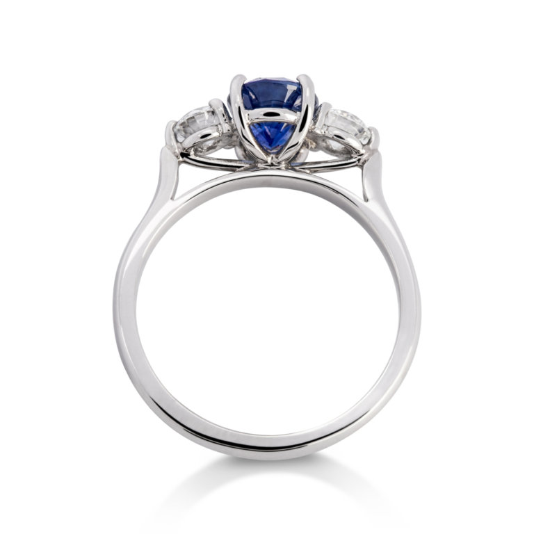 Image of an Oval Sapphire and Brilliant Cut Diamond Three Stone Ring in platinum