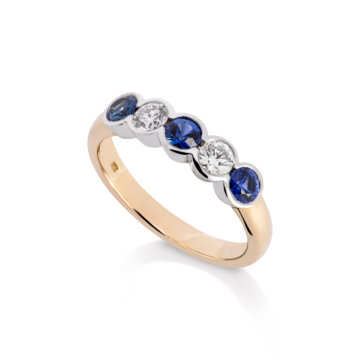 Image of a Sapphire and Diamond Rub-Over Five Stone Ring in yellow and white gold