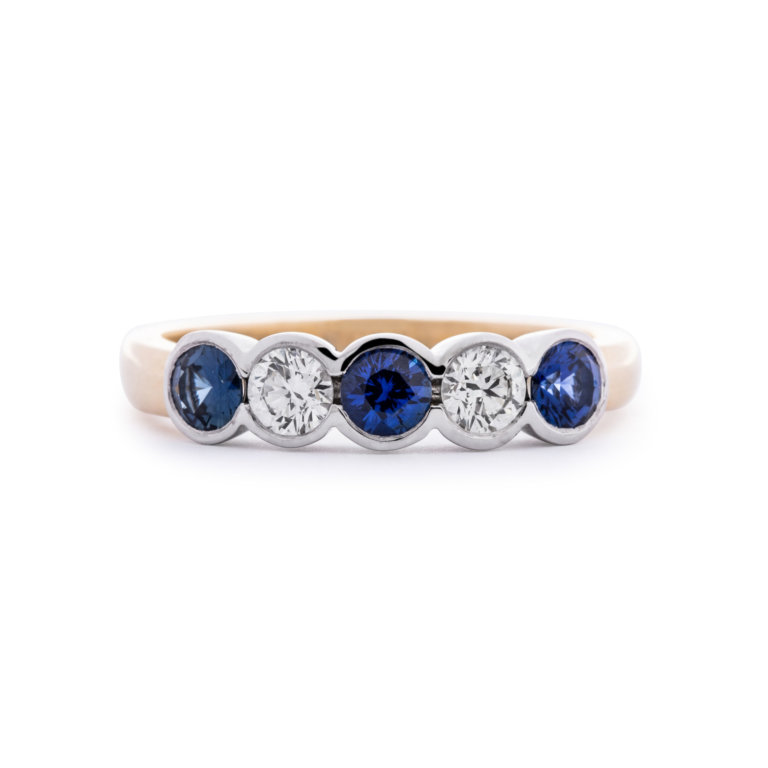 Image of a Sapphire and Diamond Rub-Over Five Stone Ring in yellow and white gold