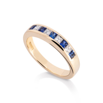 Image of a Sapphire and Diamond Channel Set Eternity Ring in yellow gold