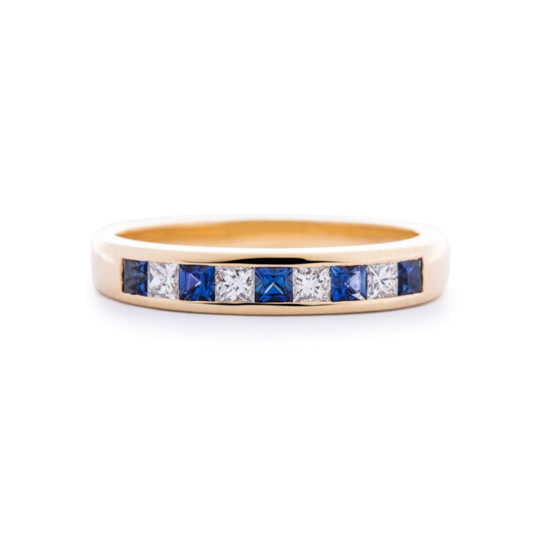 Image of a Sapphire and Diamond Channel Set Eternity Ring in yellow gold