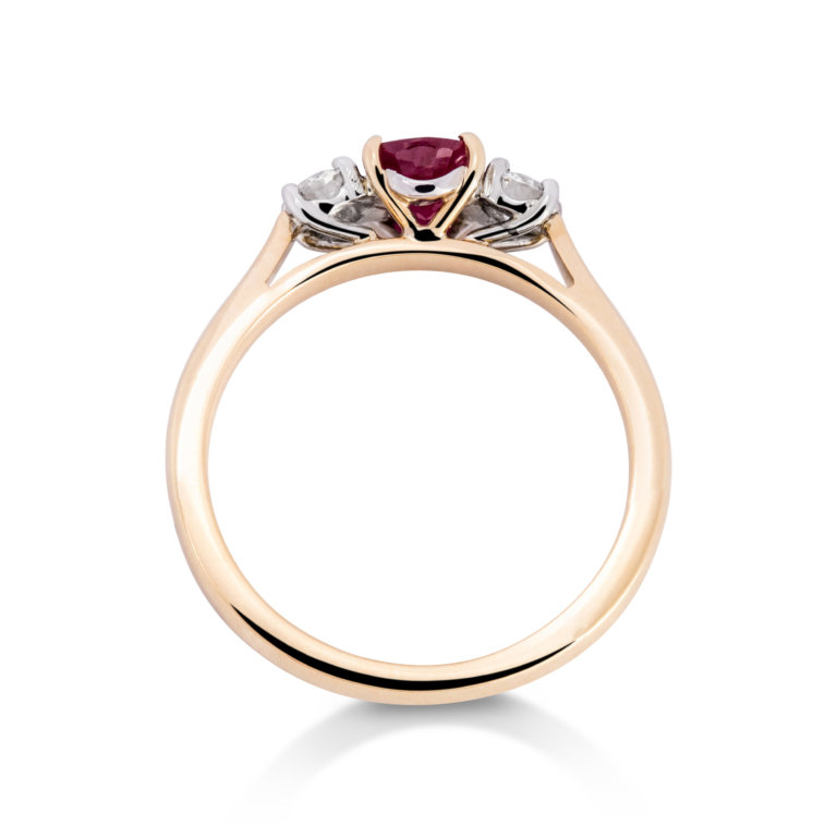 Image of an Oval Ruby and Brilliant Cut Diamond Three Stone Ring in yellow gold