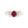 Image of an Oval Ruby and Brilliant Cut Diamond Three Stone Ring in yellow gold