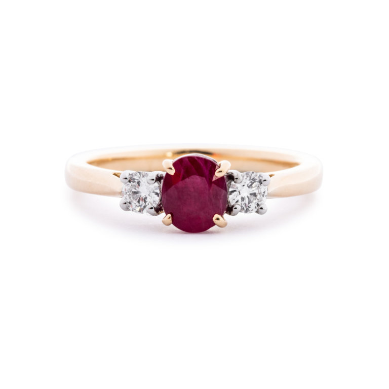 Image of an Oval Ruby and Brilliant Cut Diamond Three Stone Ring in yellow gold