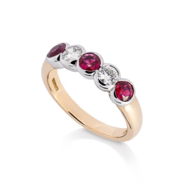 Image of a ruby and Diamond Rub-Over Five Stone Ring in yellow and white gold