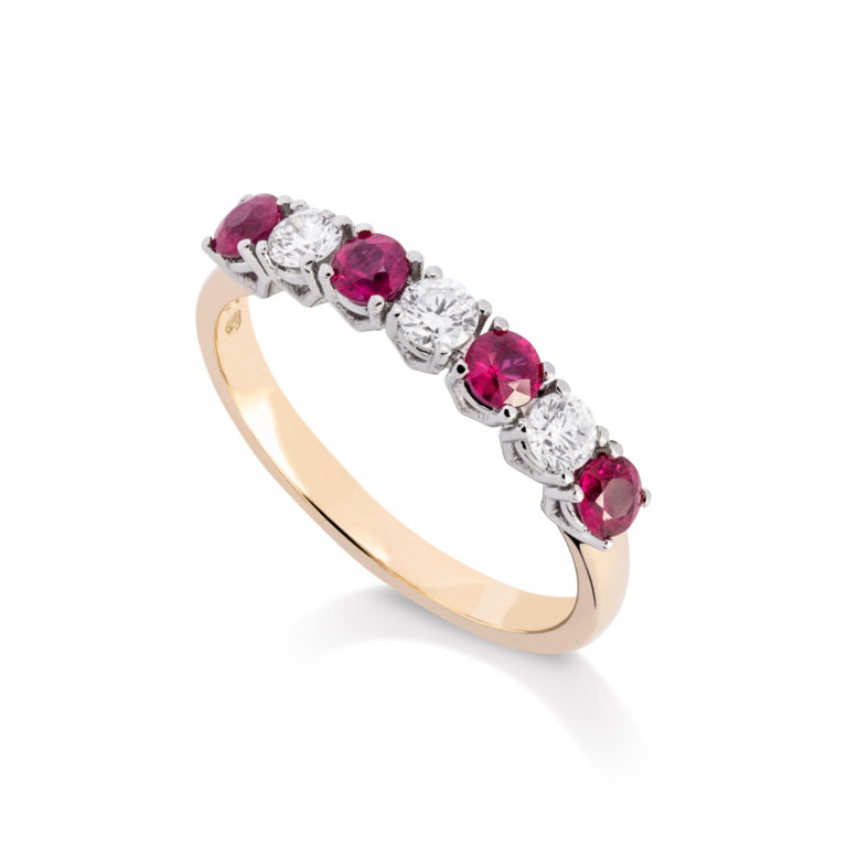 Image of a ruby and diamond claw set eternity ring in yellow gold and platinum