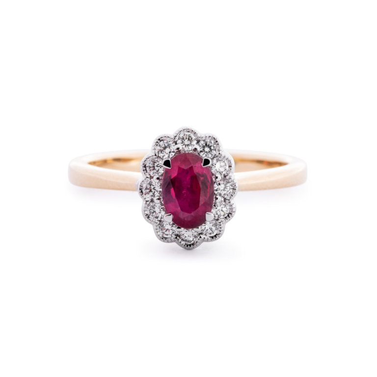 Image of a Ruby and Diamond Oval Cluster Ring in yellow gold