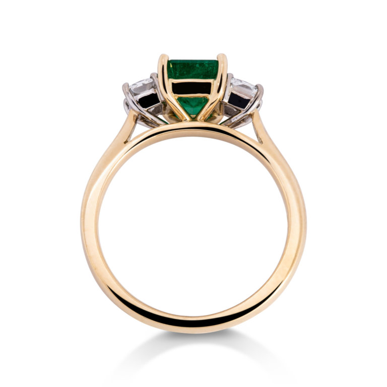 Image of an Emerald Cut Emerald and Radiant Cut Diamond Three Stone Ring set in yellow and white gold