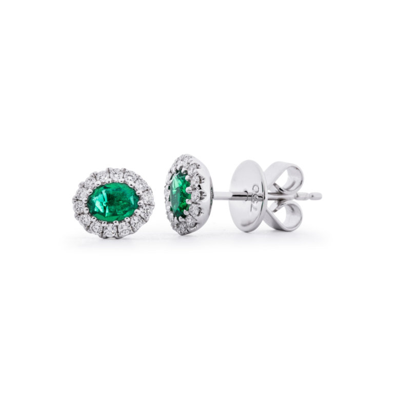 Image of a pair of diamonds and emerald earrings in white gold.