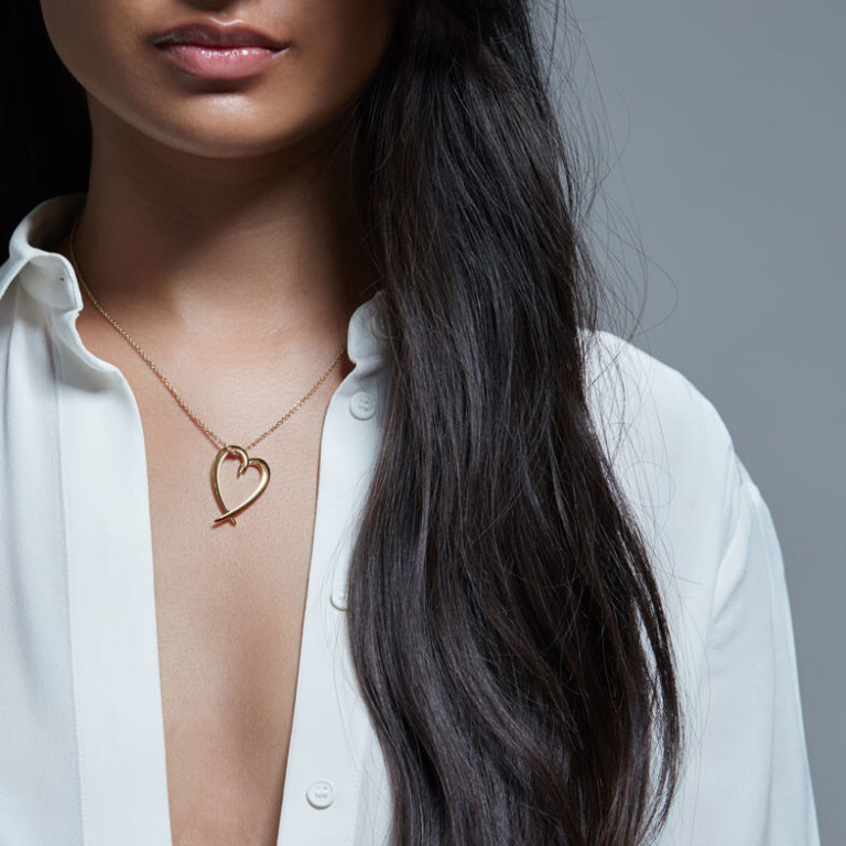 Image of a lady wearing a Shaun Leane Yellow Gold Vermeil Hook Heart Pendant